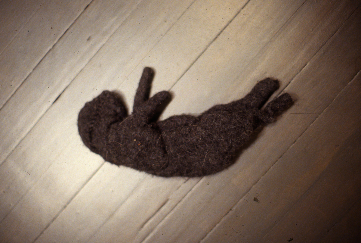 Installation view of the group show trophy, sculpture of animal laying on the ground.