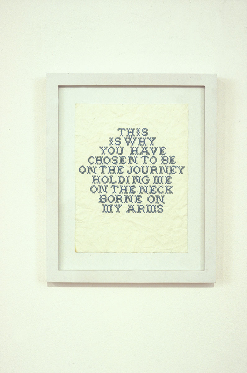 Ginger Brooks Takahashi, image of embroidery black text, framed. 