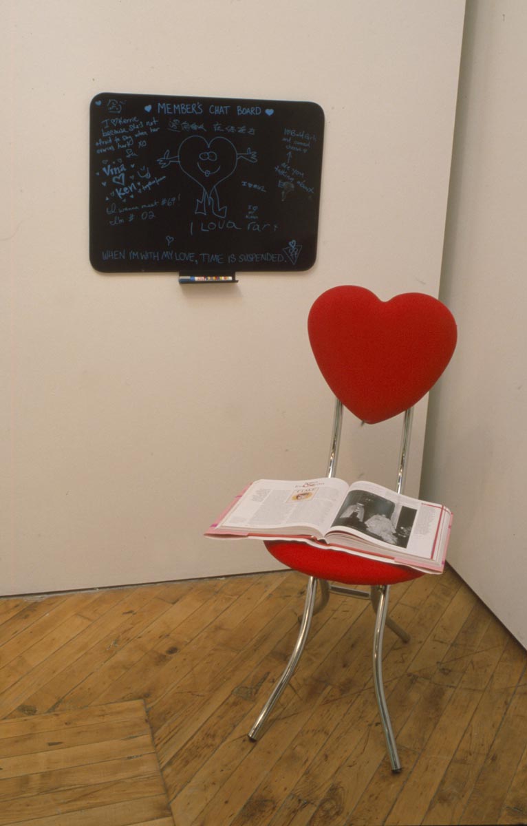 Clara Ursitti: Installation view, TV and heart shaped chair.