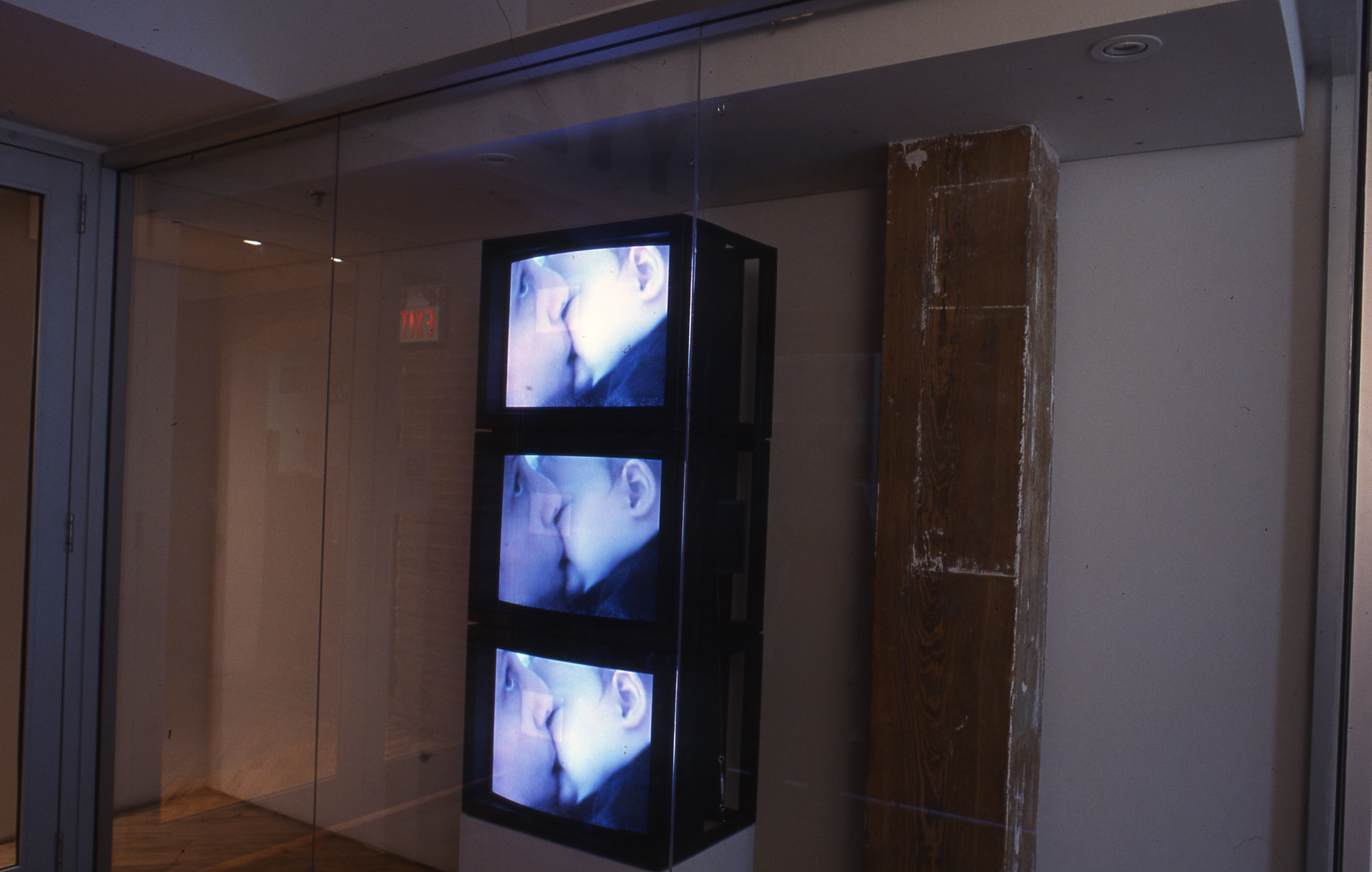 Lyla Rye: Window display, two people engages in a kiss, multiple monitors