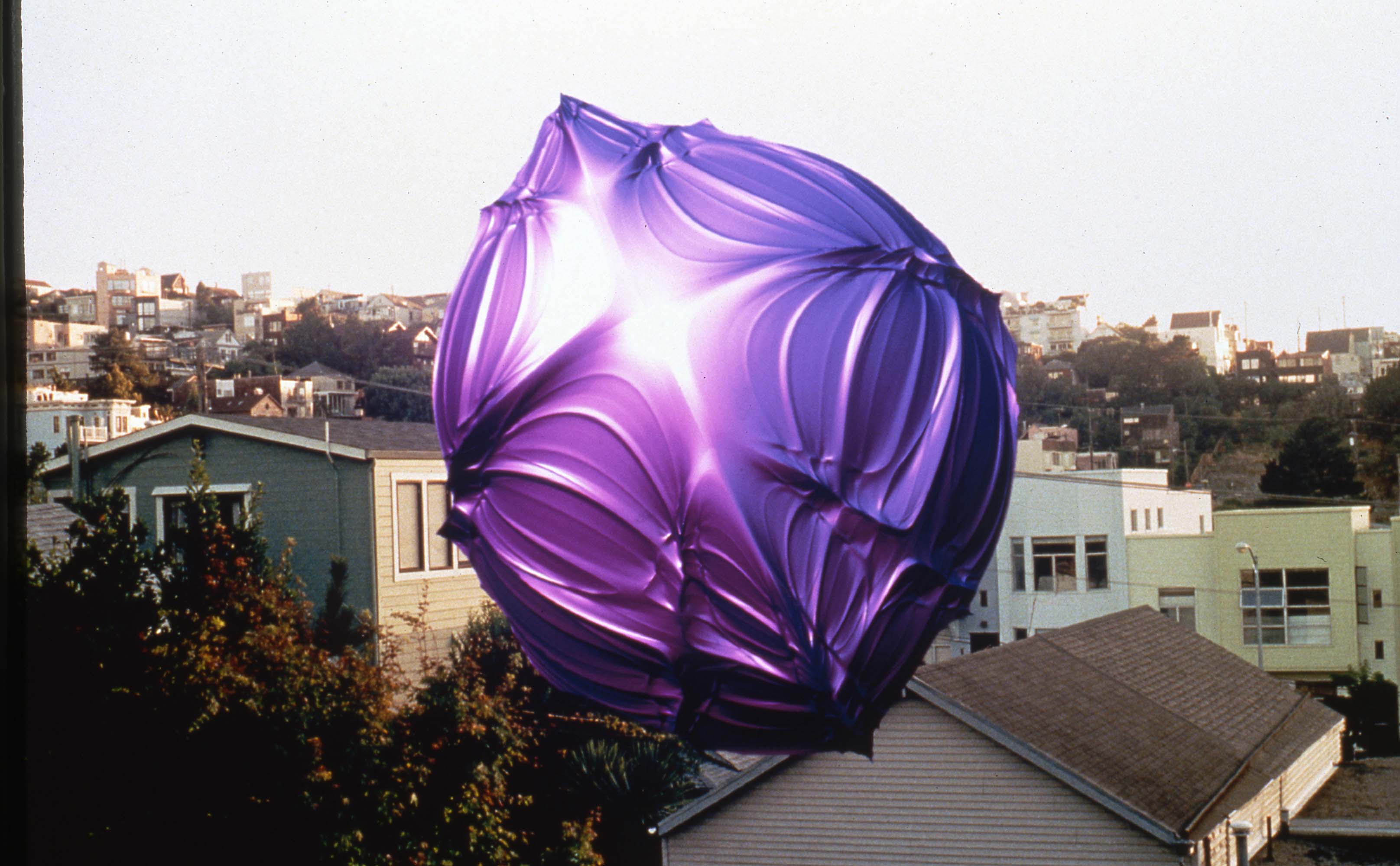 Holly Armishaw: Image of a purple balloon, housing complex in the background.