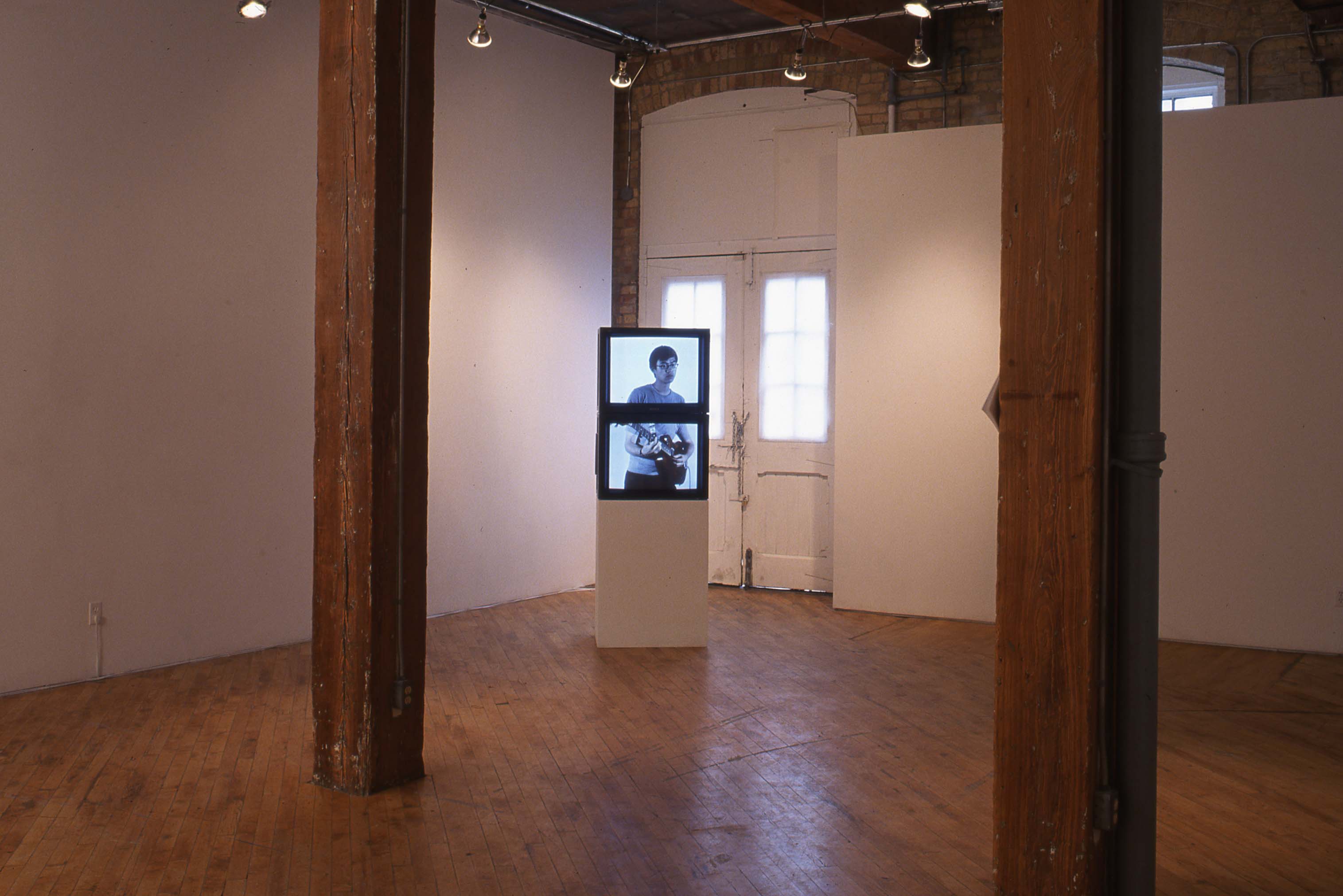 Tim Lee: Installation view of multi channel TV installation, two TV's are stacked on top of one another..