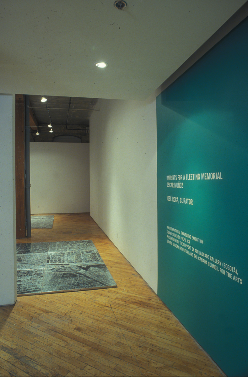 Oscar Munoz: Installation view.He experiments with several techniques in what he refers to image-making in an expanded field, innovating processes on improbable substrates, including silk-screen on water, airbrush drawing on dripping-wet Mylar, and screen-printing with grease on mirrors.