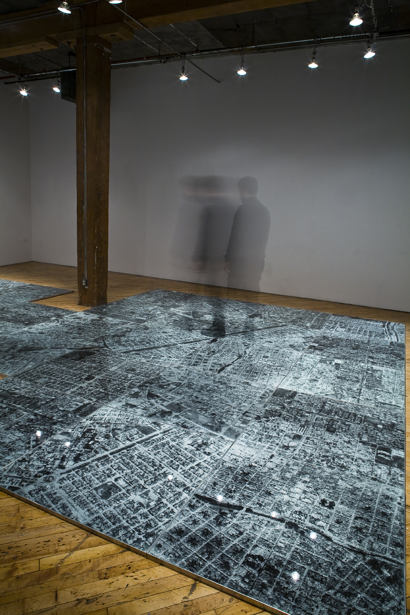 Oscar Munoz: Installation view.He experiments with several techniques in what he refers to image-making in an expanded field, innovating processes on improbable substrates, including silk-screen on water, airbrush drawing on dripping-wet Mylar, and screen-printing with grease on mirrors.