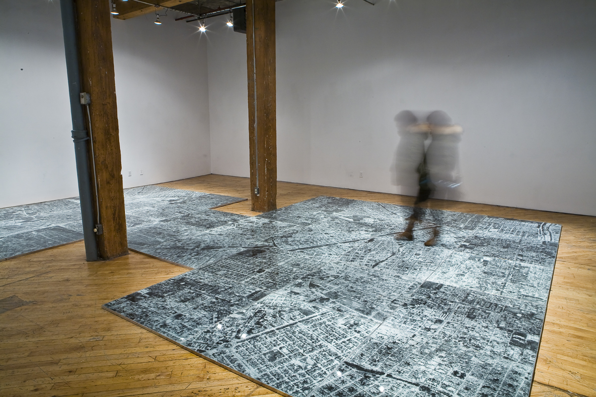 Oscar Munoz: Installation view.He experiments with several techniques in what he refers to image-making in an expanded field, innovating processes on improbable substrates, including silk-screen on water, airbrush drawing on dripping-wet Mylar, and screen-printing with grease on mirrors.