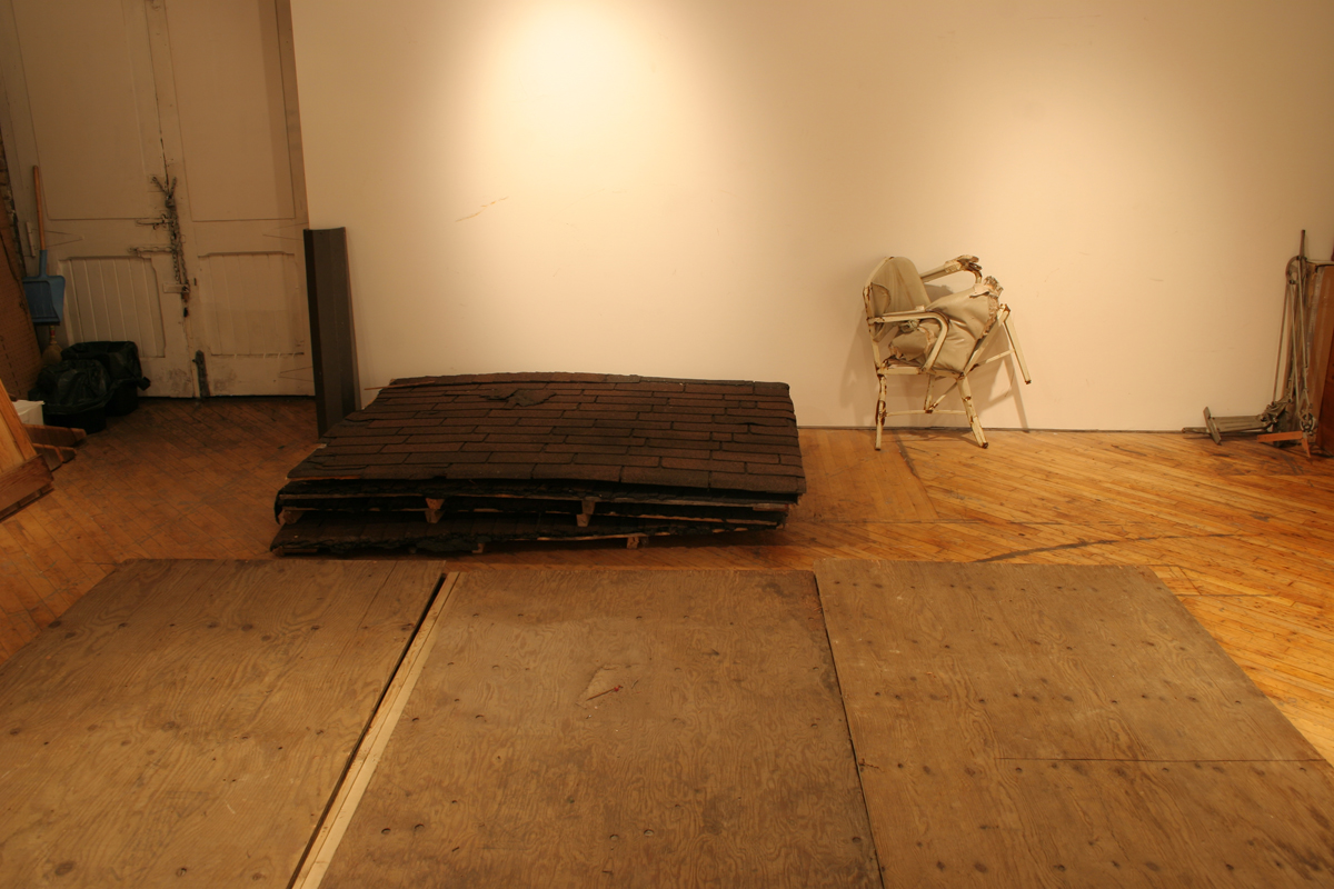 Swintak: Residency, image of building supplies assembled along the gallery wall..