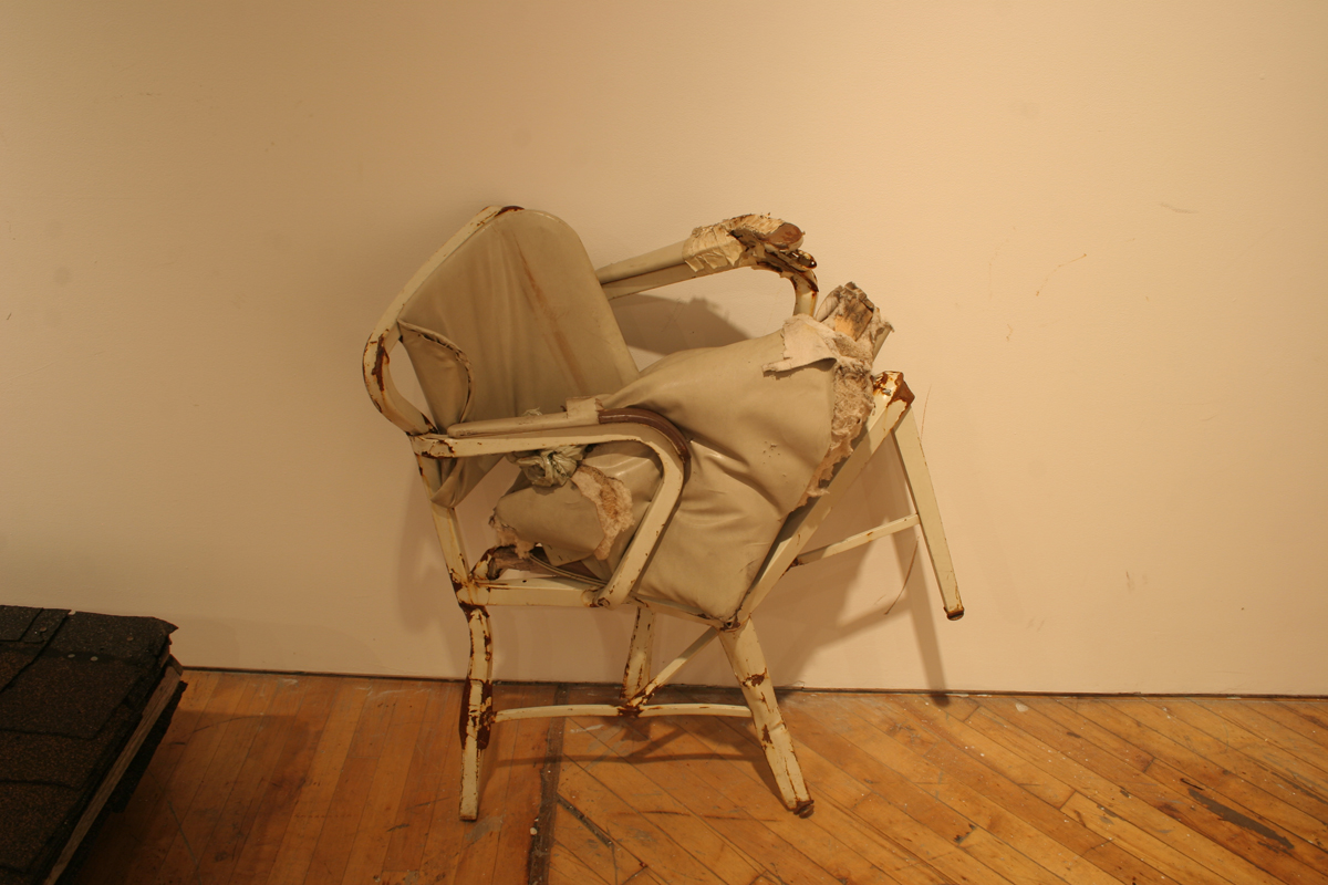 Swintak: Residency, image of outdoor chairs piled on one another..