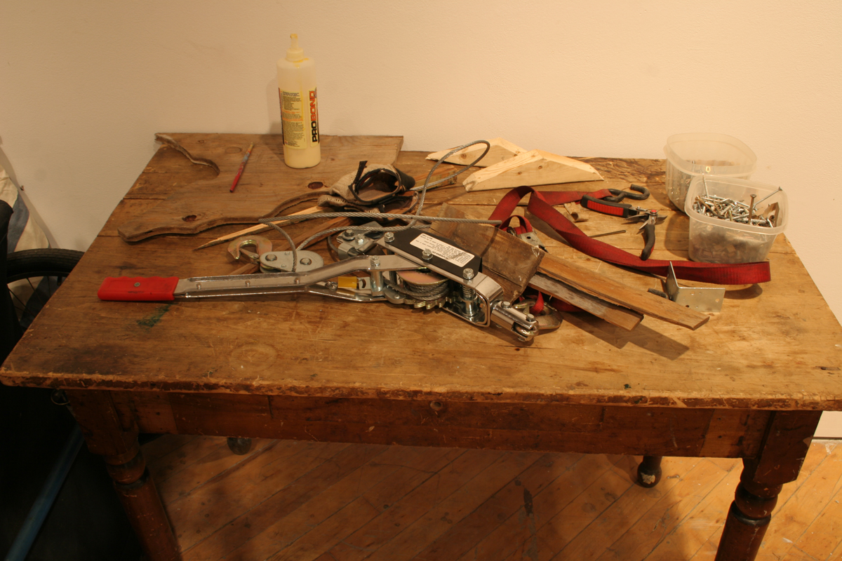 Swintak: Residency, image of tools on wooden desk, laid out.