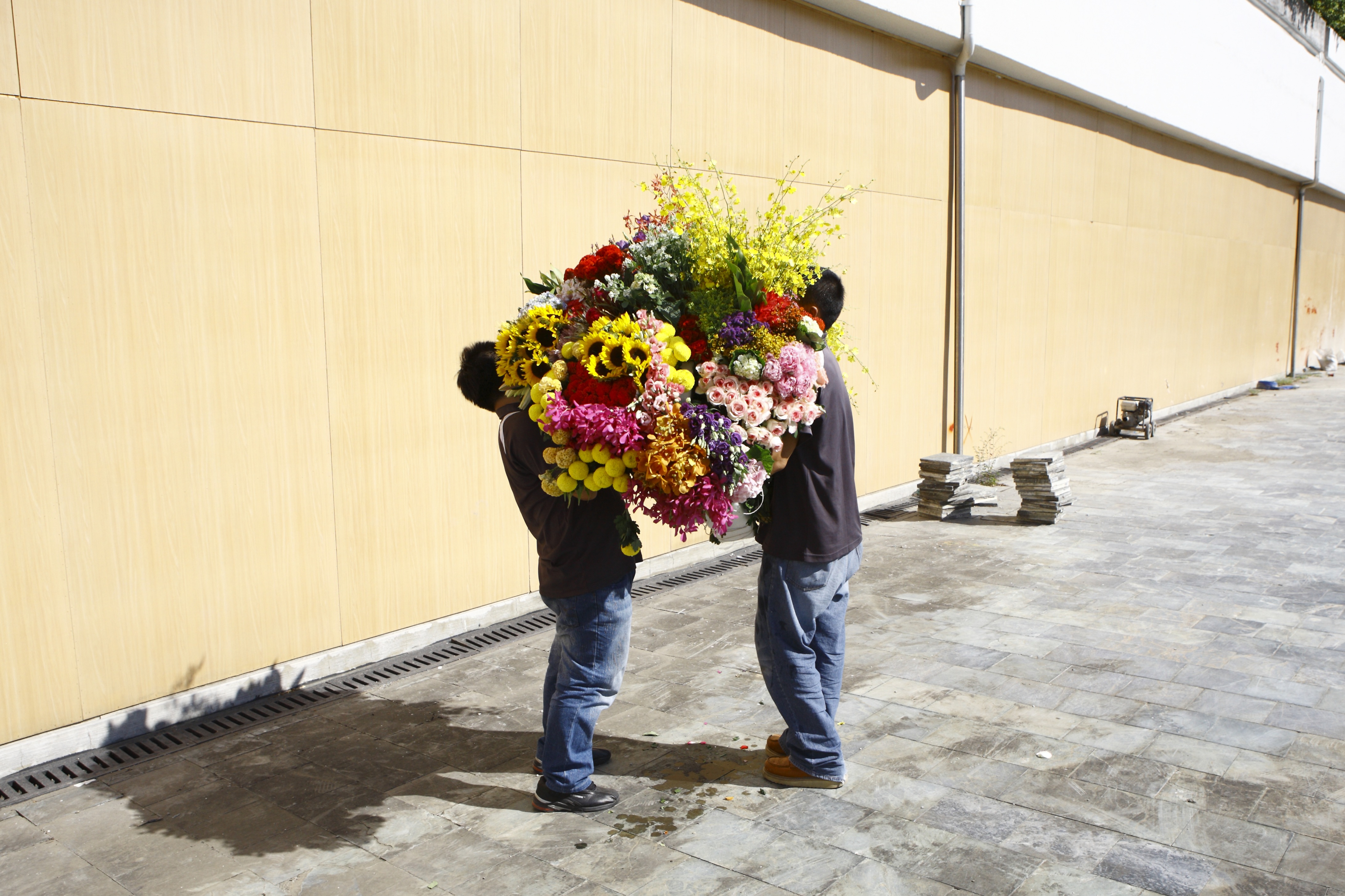 KOKI TANAKA, image of men holding flowers.