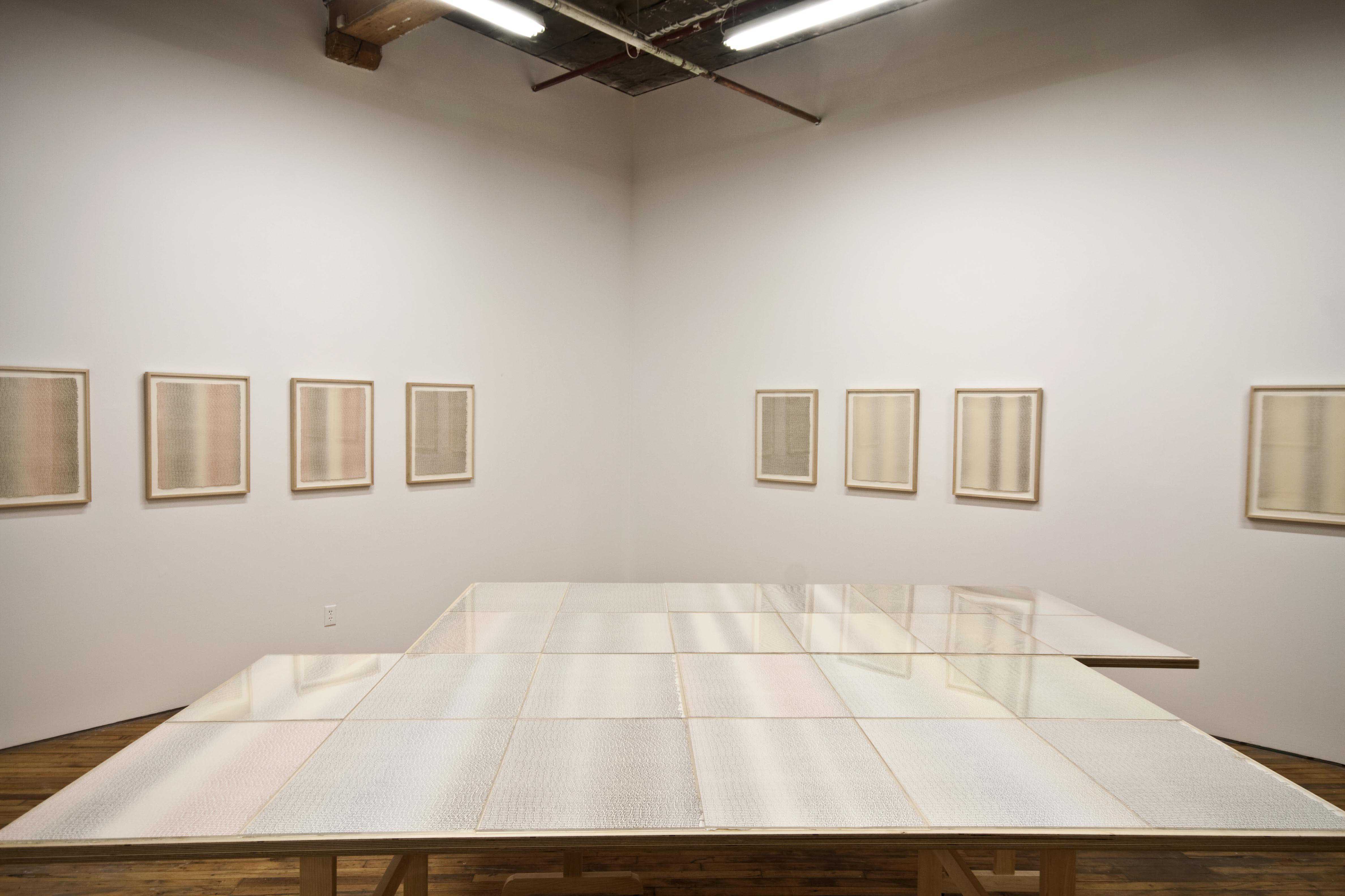 Barbara Balfour, installation view of Living and Dying, images of writing permeate the gallery, printed images hang on the wall.