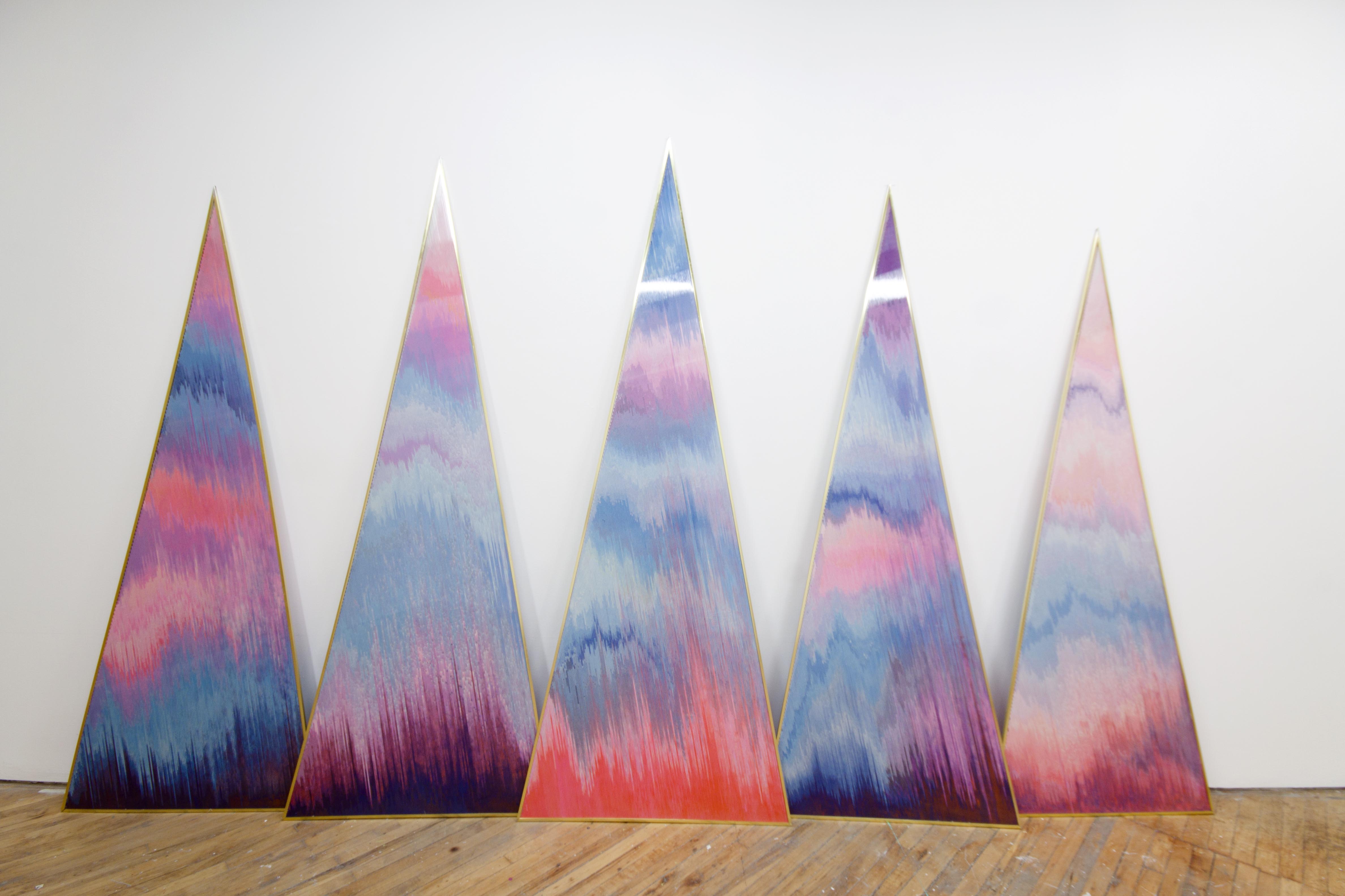 Lauren Hall, installation viewvcoloured sand, soap, and gold lighting panels as sites of natural phenomena, installation view of Triangular pastel coloured sculpture. pieces.