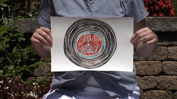 Julie Lequin, woman holding drawing of bullseye.