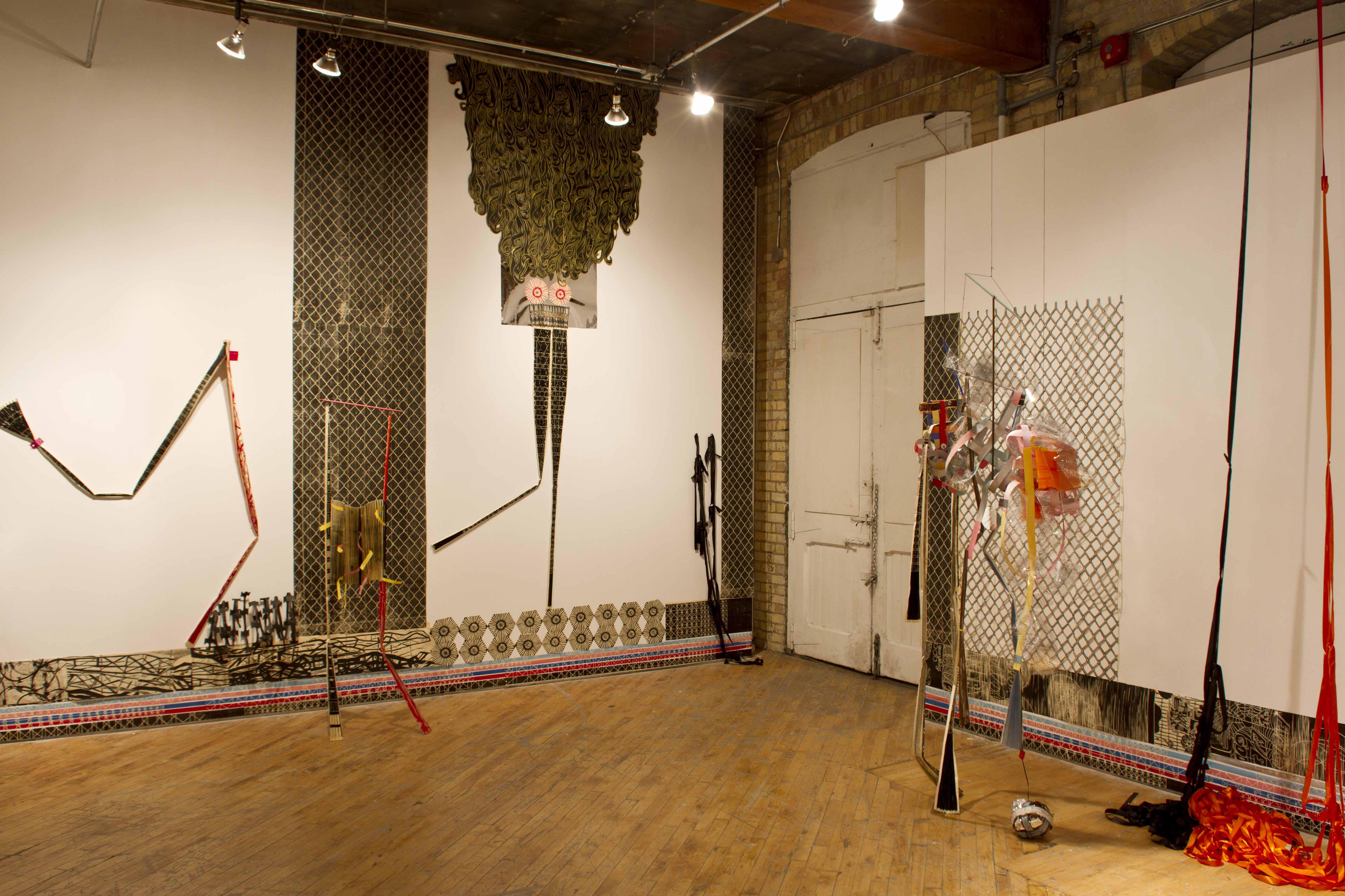Libby Hague, installation view immersive woodcut, suspended abstract puppets.
