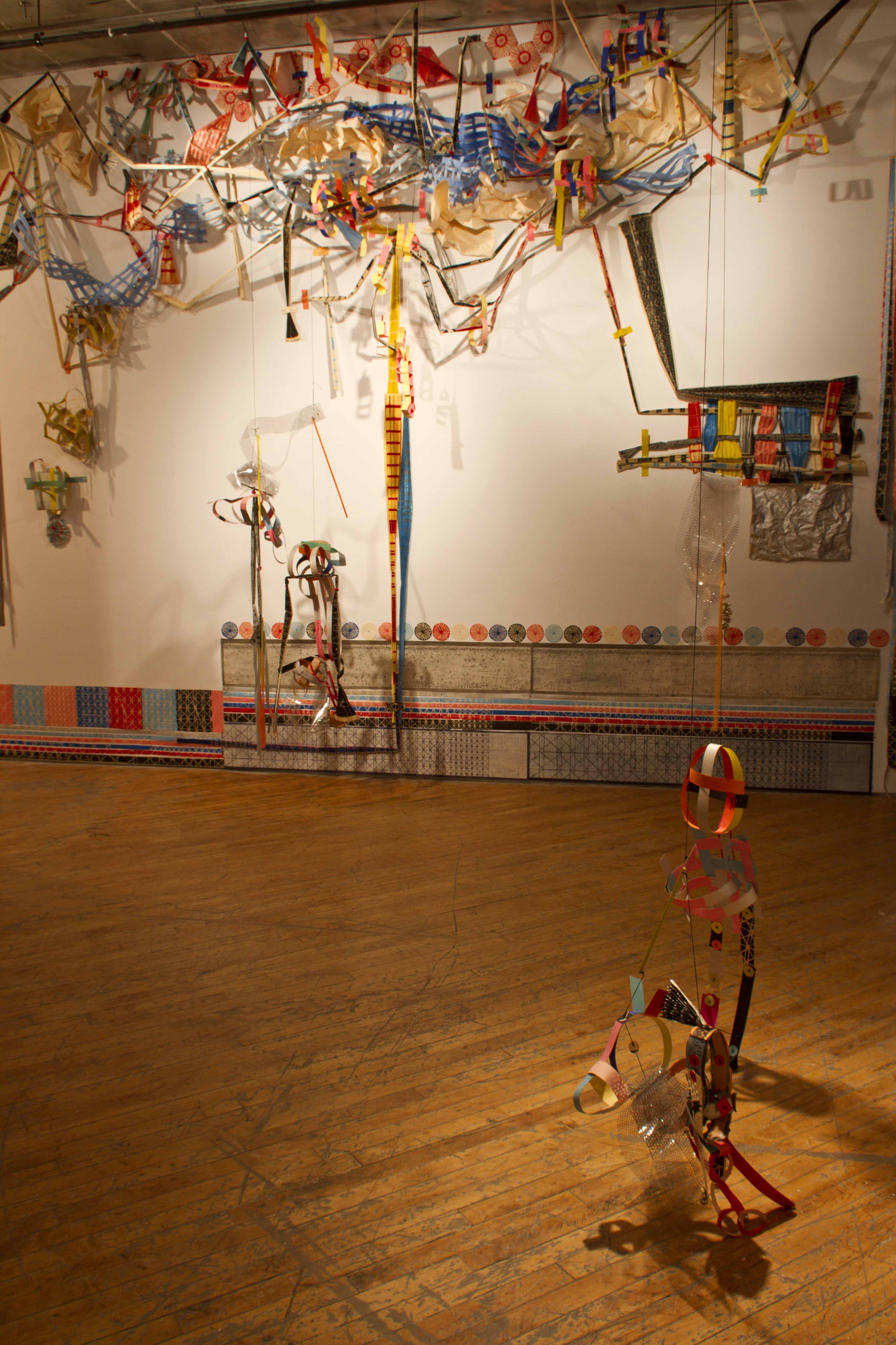 Libby Hague, installation view immersive woodcut, suspended abstract puppets.