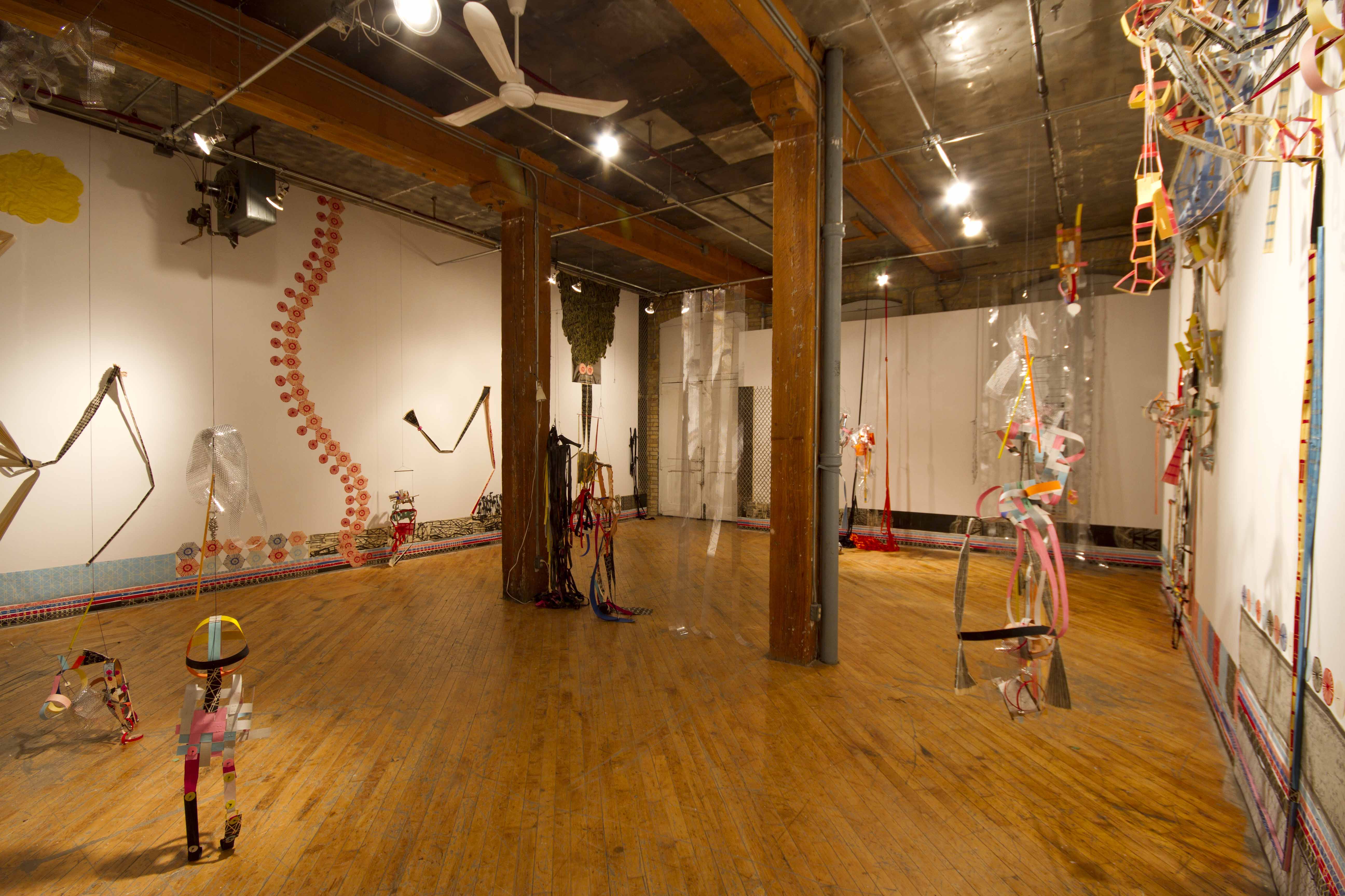 Libby Hague, installation view immersive woodcut, suspended abstract puppets.