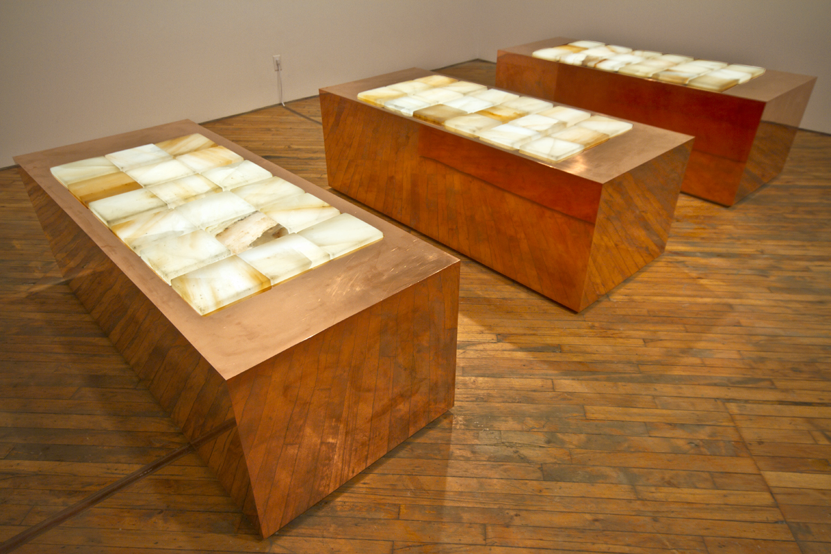 Faith La Rocque, installation view, three copper plinths aligned in a row, with Himalayan salt layered on top, create a sensory experience.
