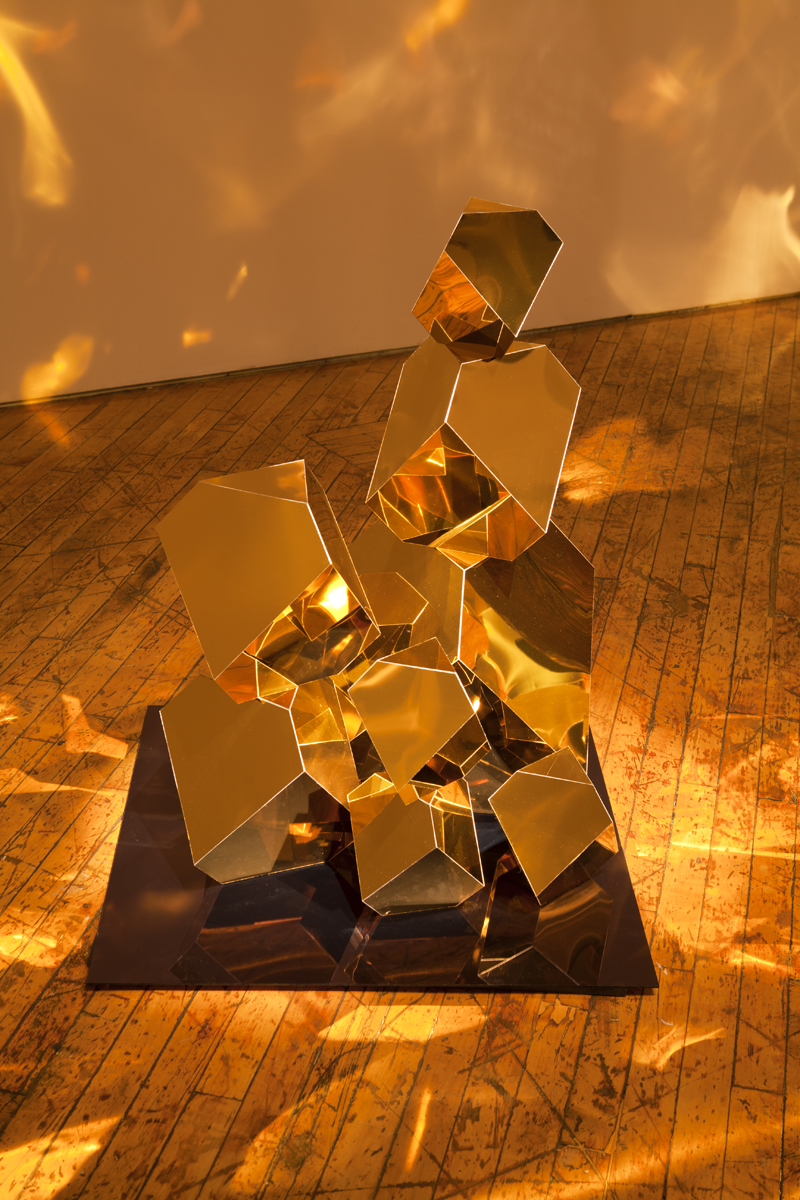 Jade Rude, installation view of gold sculpture with projected reflective lights.