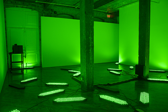 Jon Sasaki, installation view, fluorescent green lighting.