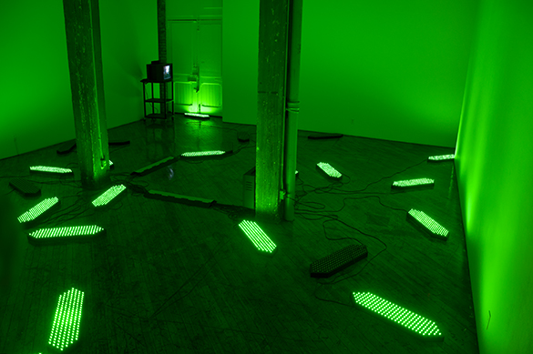 Jon Sasaki, installation view, fluorescent green lighting.