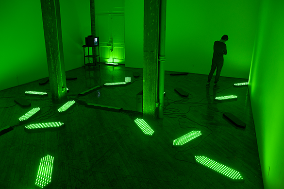 Jon Sasaki, installation view, fluorescent green lighting.