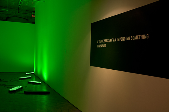Jon Sasaki, installation view, fluorescent green lighting.