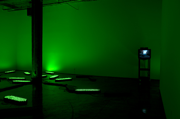 Jon Sasaki, installation view, fluorescent green lighting.
