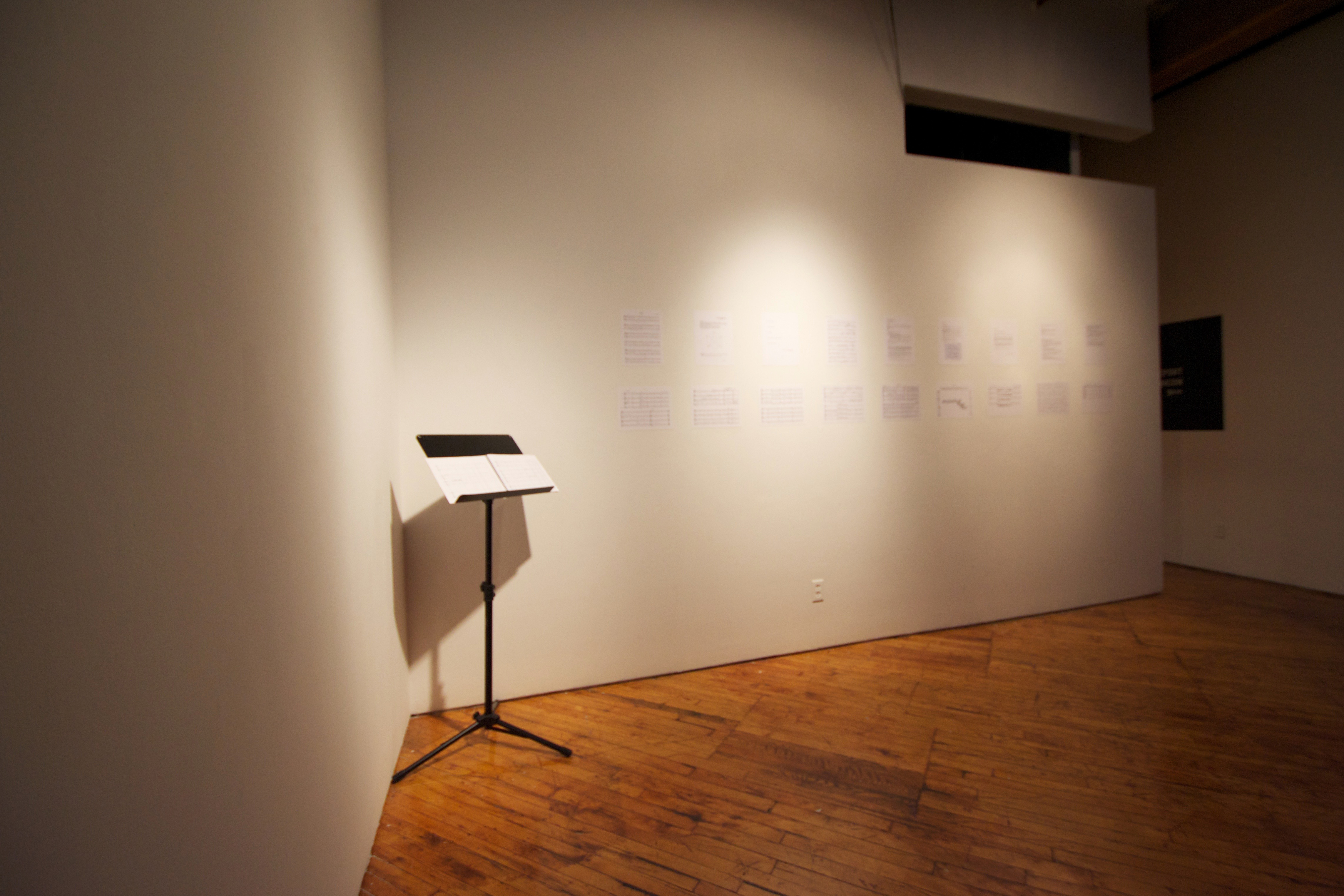 Raven Chacon, installation view, music stand and images.