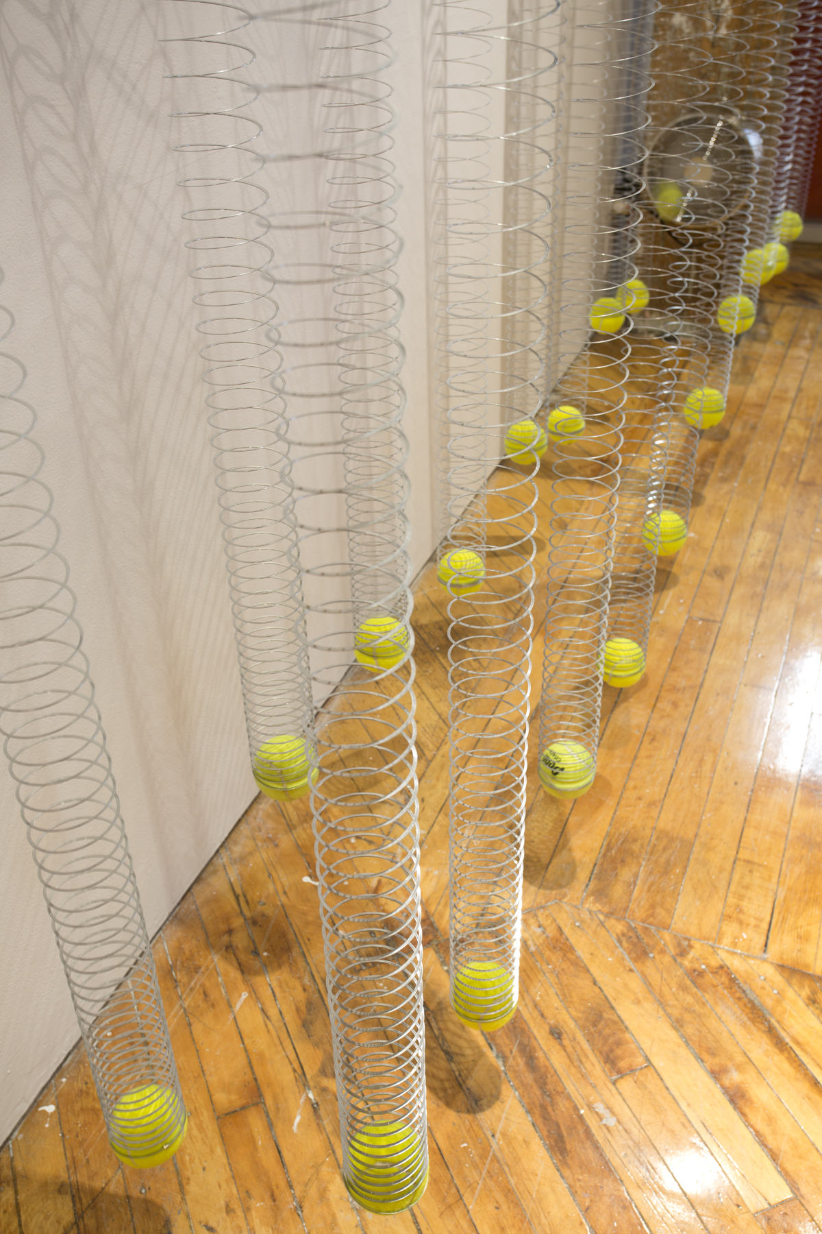Lana Yuan, window installation, bouncy balls with slinkies.
