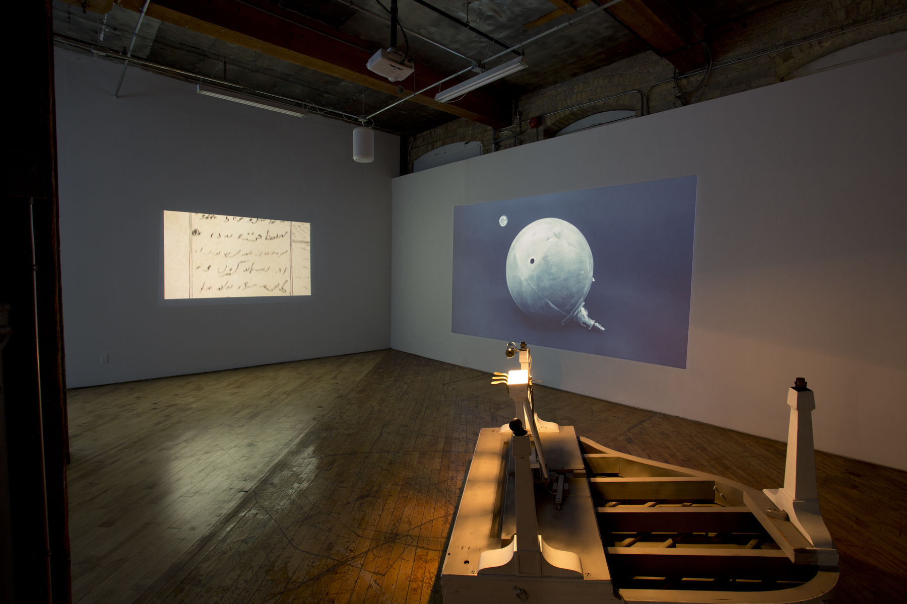 Installation View: The South Gallery, Arrivals, features work of four video artists, projections and upside down piano.