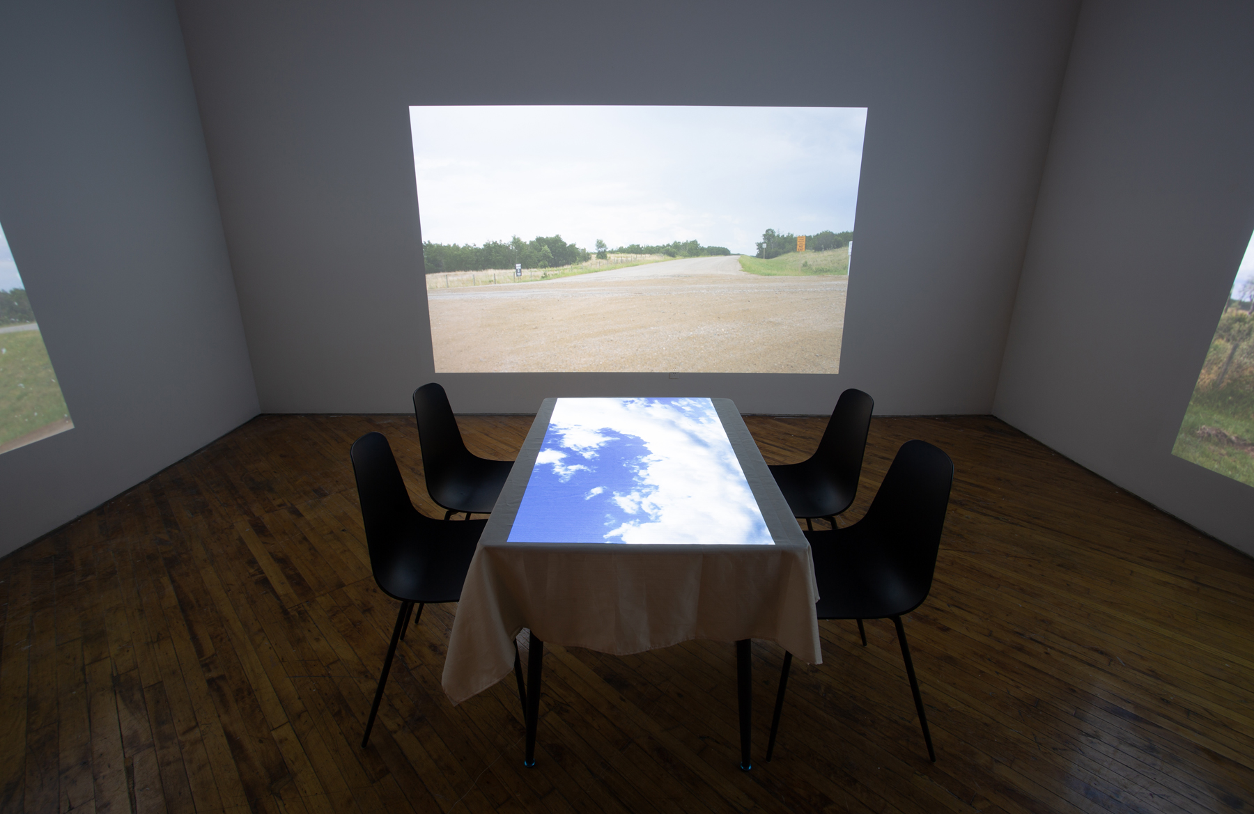 Theo Jean Cuthand, installation view, table and projection.