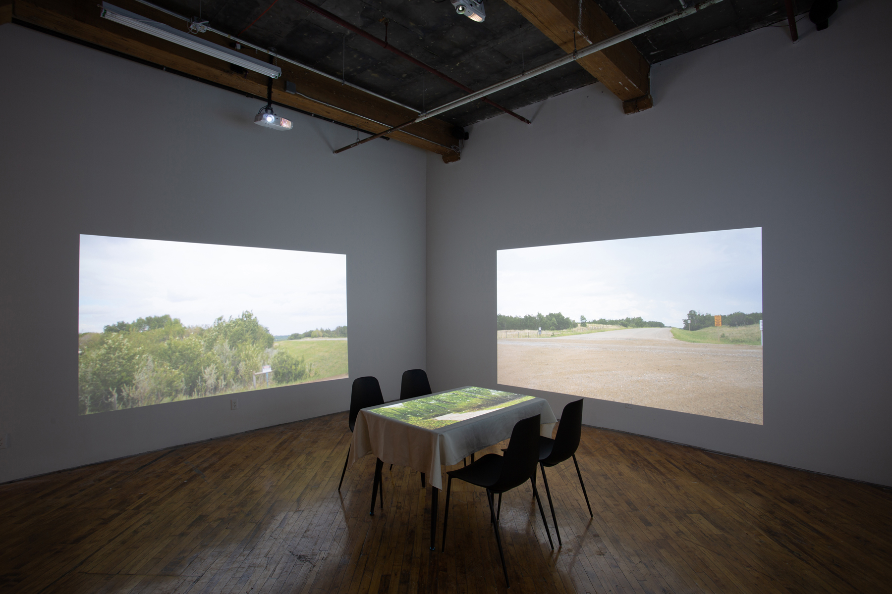 Theo Jean Cuthand, installation view, table and projection.