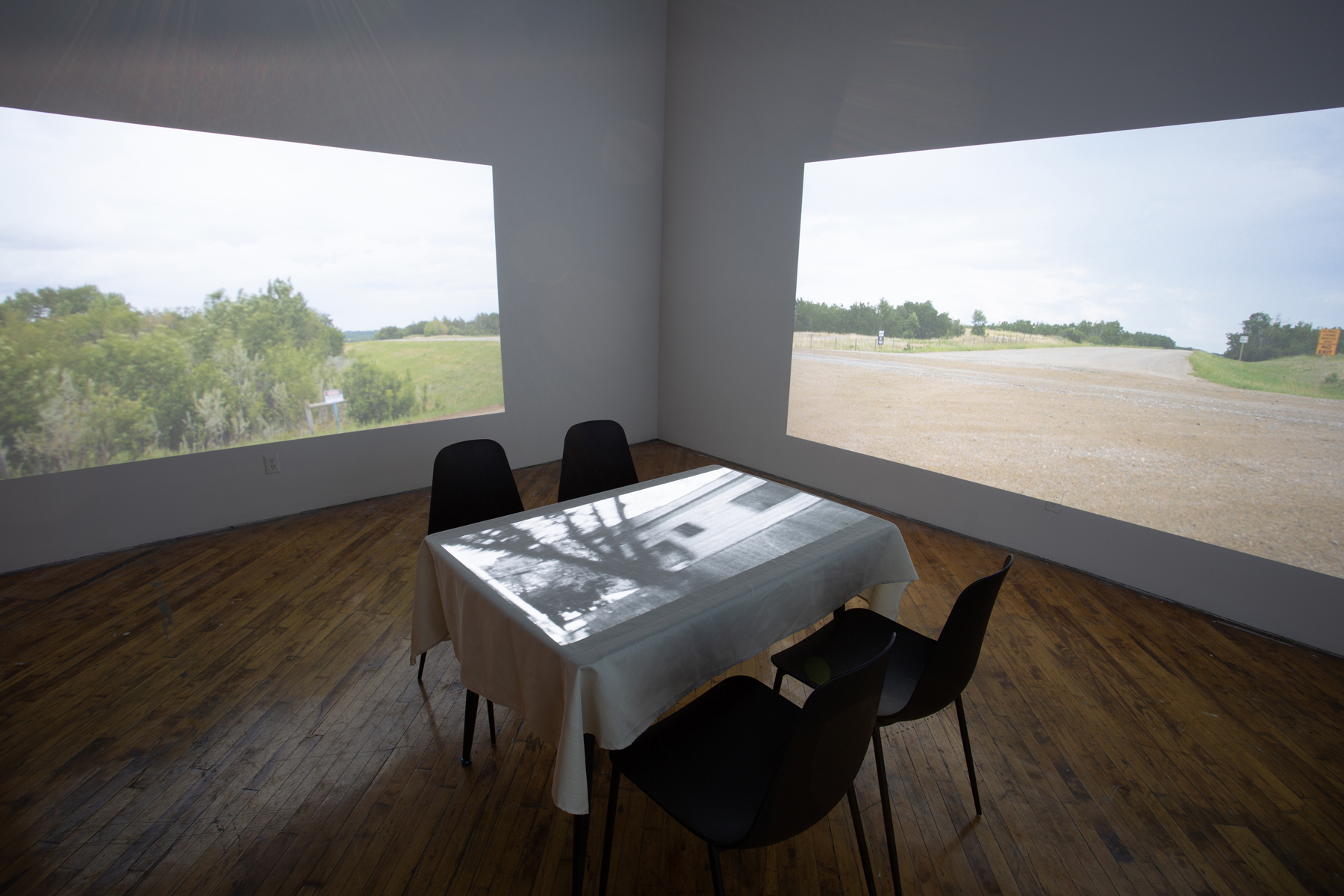 Theo Jean Cuthand, installation view, table and projection.