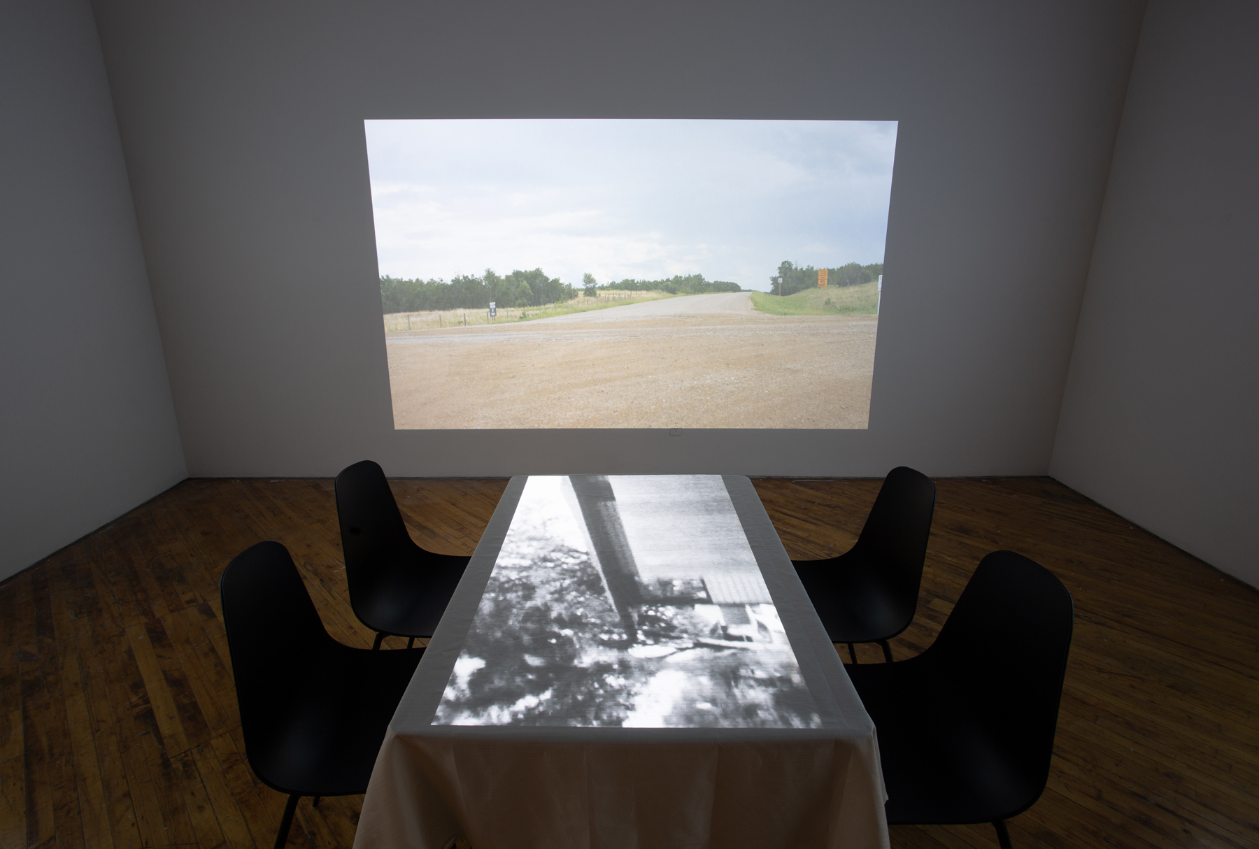 Theo Jean Cuthand, installation view, table and projection.