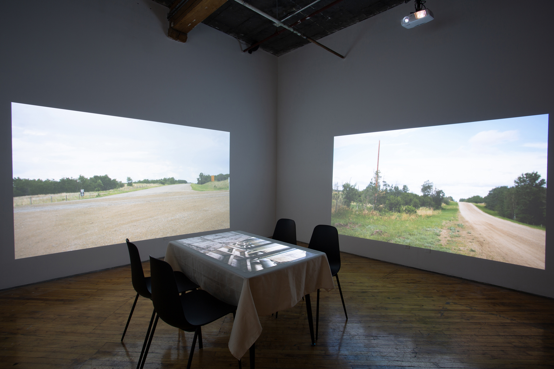 Theo Jean Cuthand, installation view, table and projection.