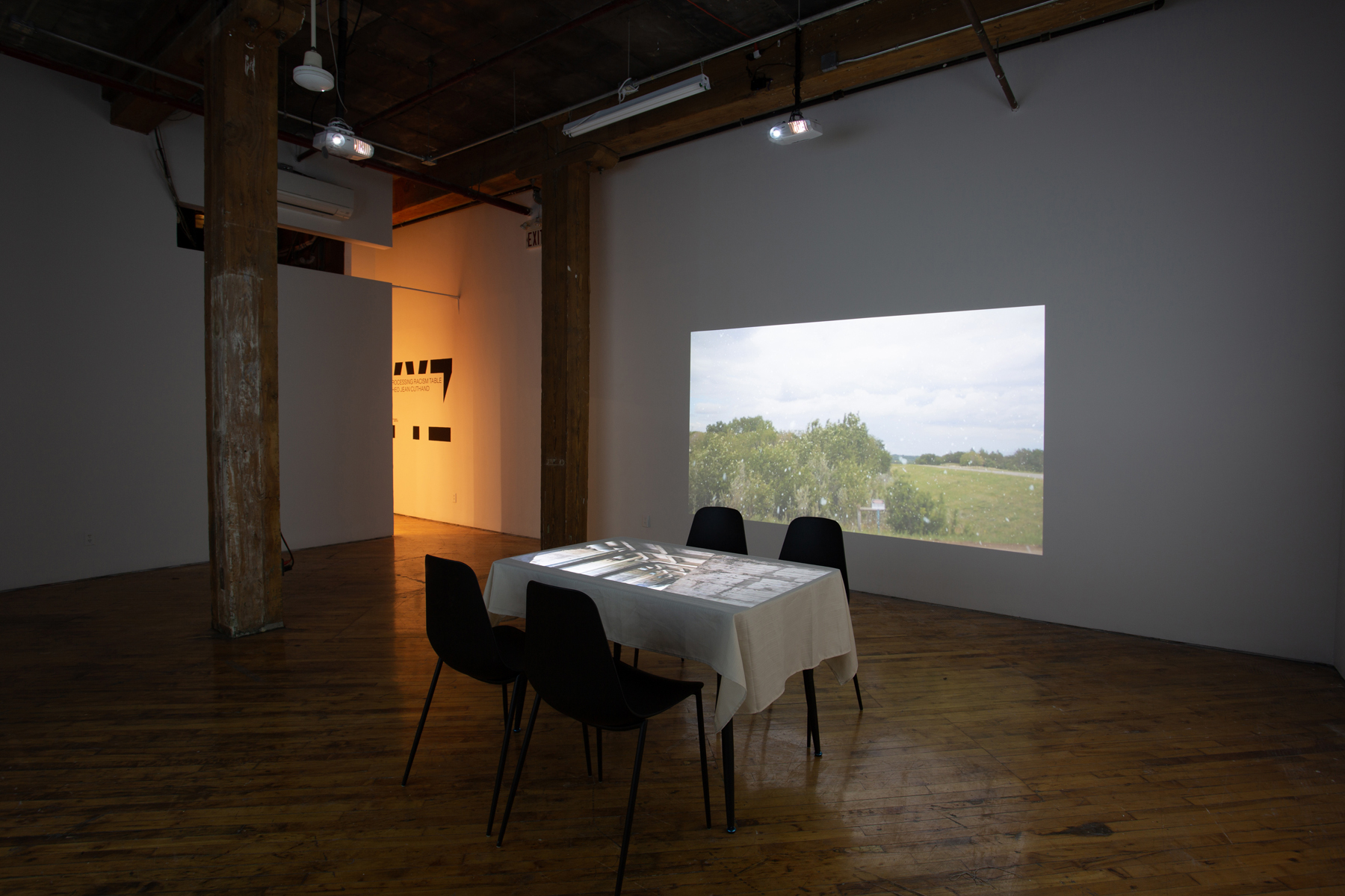Theo Jean Cuthand, installation view, table and projection.