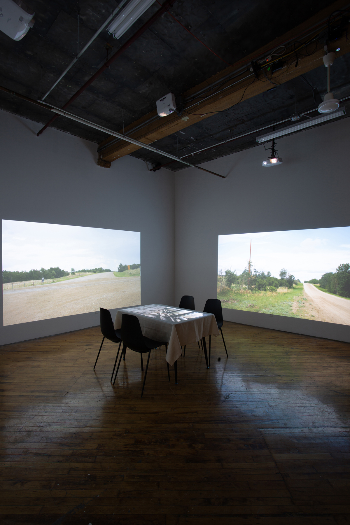 Theo Jean Cuthand, installation view, table and projection.