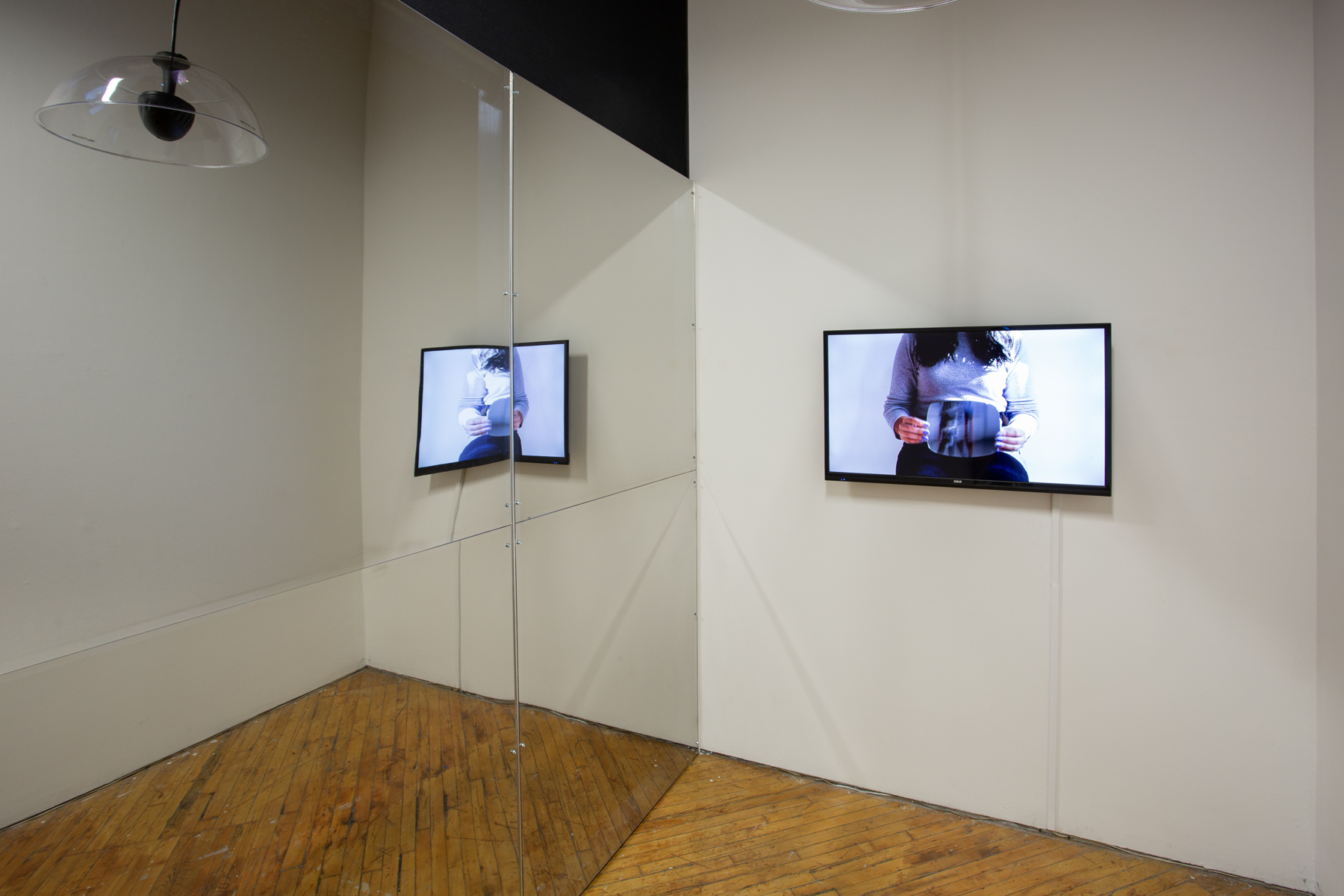 Zinnia Naqvi, view of installation, mirror and monitor.