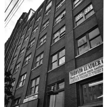 A black and white photo of the outside of a building on Spadina