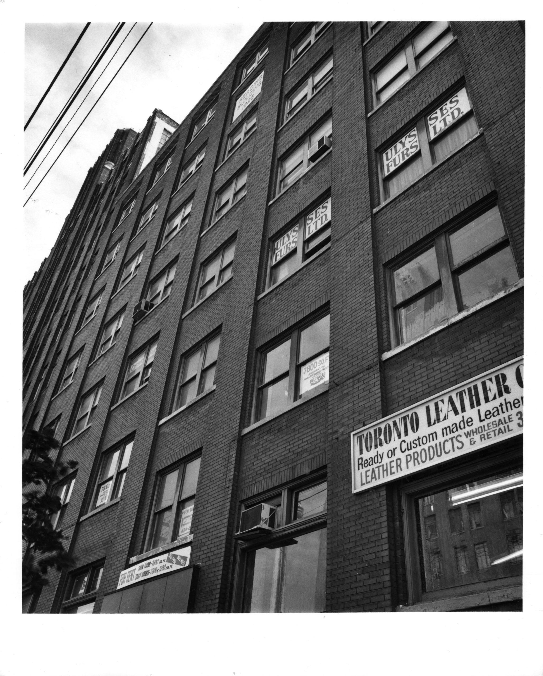 A black and white photo of the outside of a building on Spadina