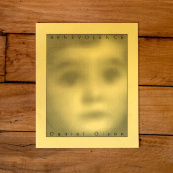 A yellow duotone image of an obscured child's face titled 