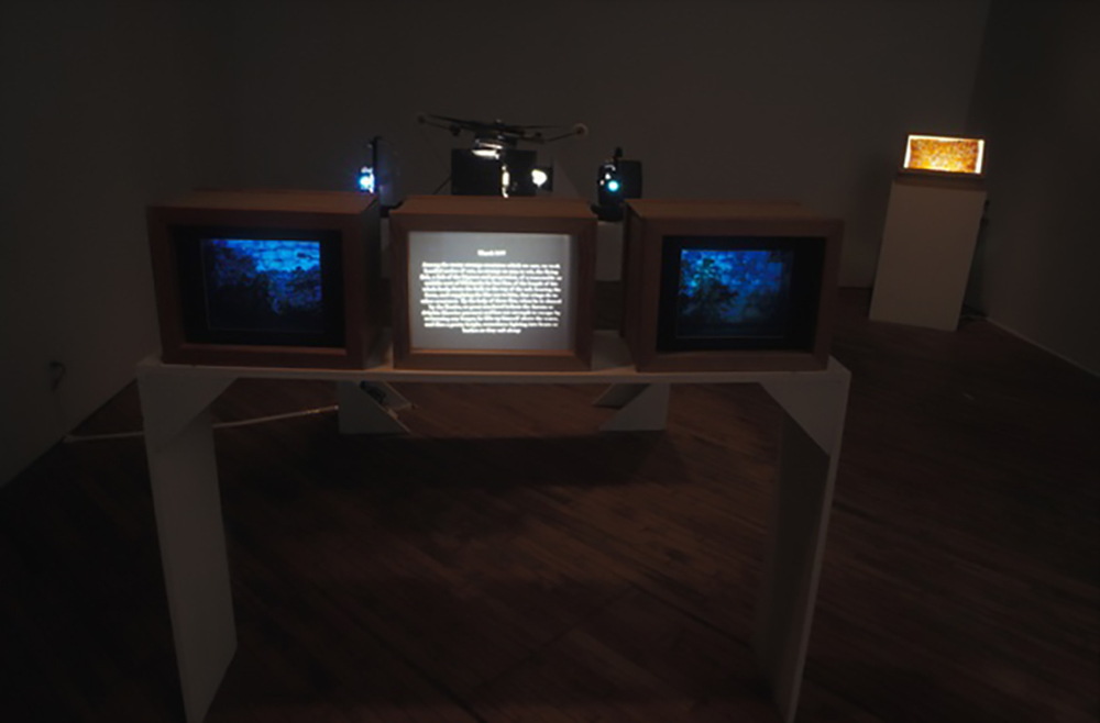 2 vintage TVs in a row on a table