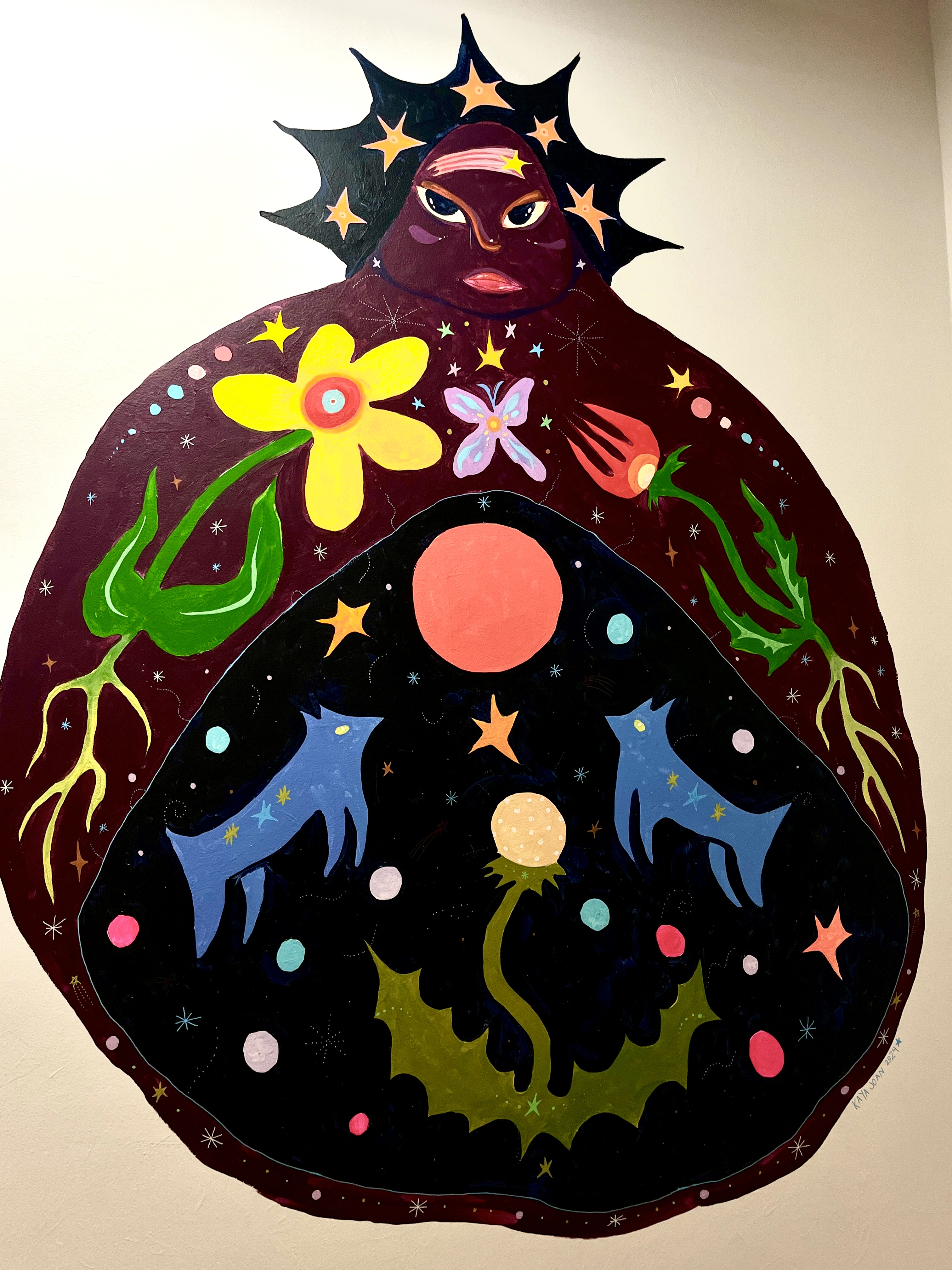 Drawing of a dark circle with a woman's head. The circle contains colourful graphic elements like flowers and animals.