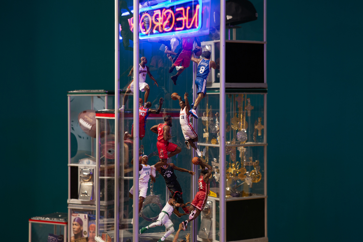 Oluseye: Installation view, detail of action figures playing basketball in vending machine