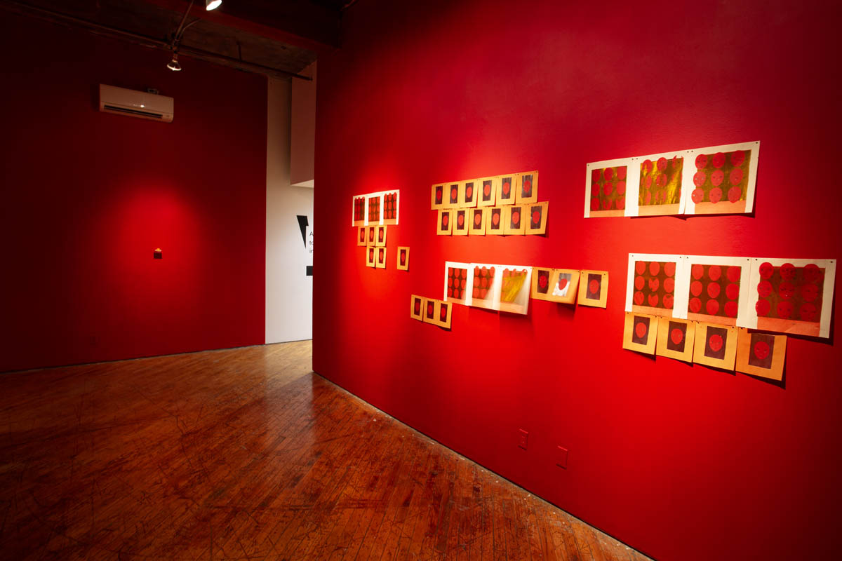 Annie Wong, hand made prints in motion, gallery walls are painted red.