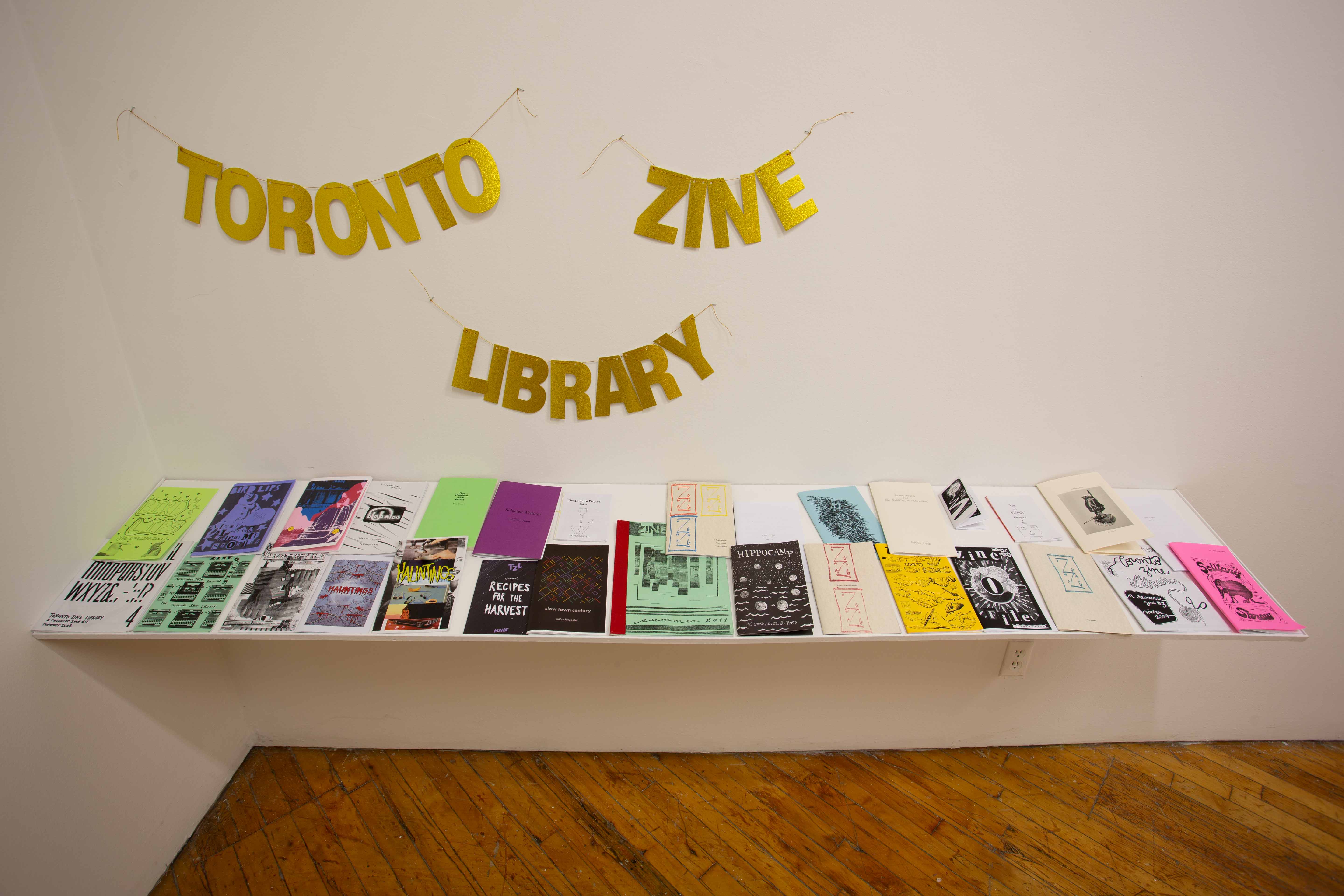 shelf with various zines from the Toronto Zine Library