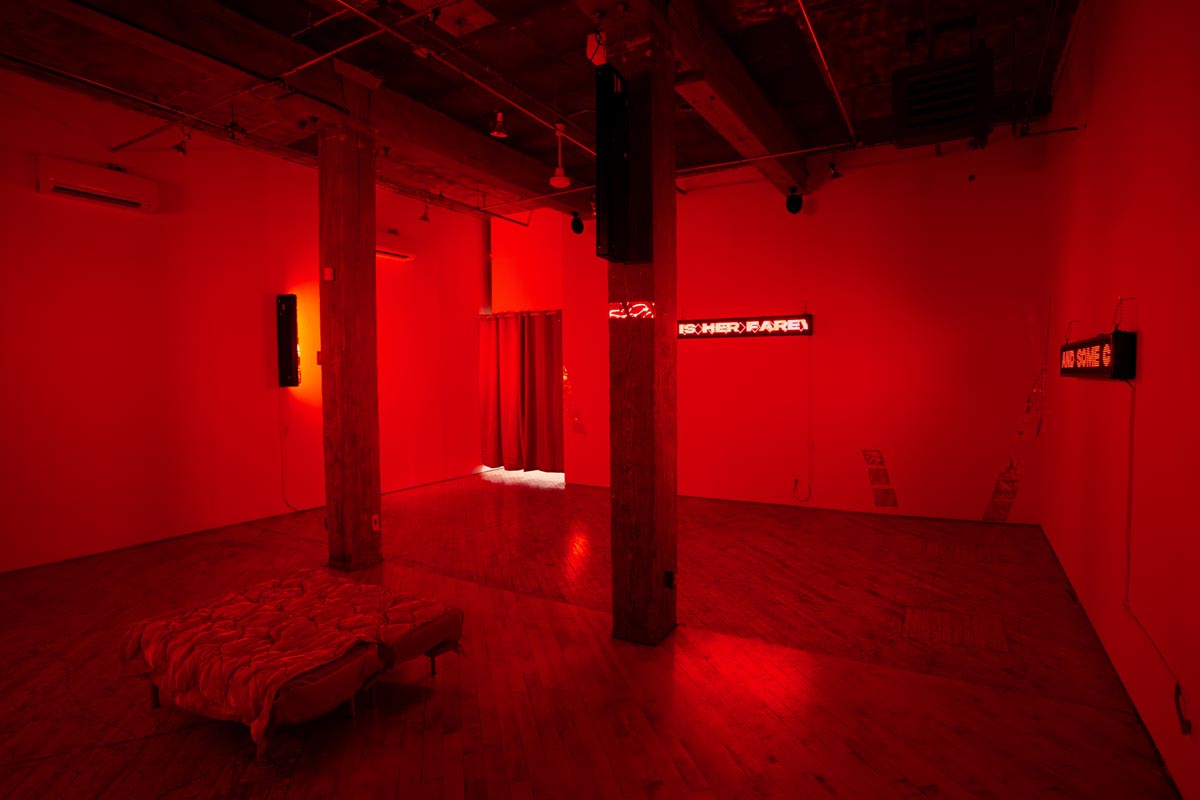 Installation View, red room, dim lights, with LED signs.