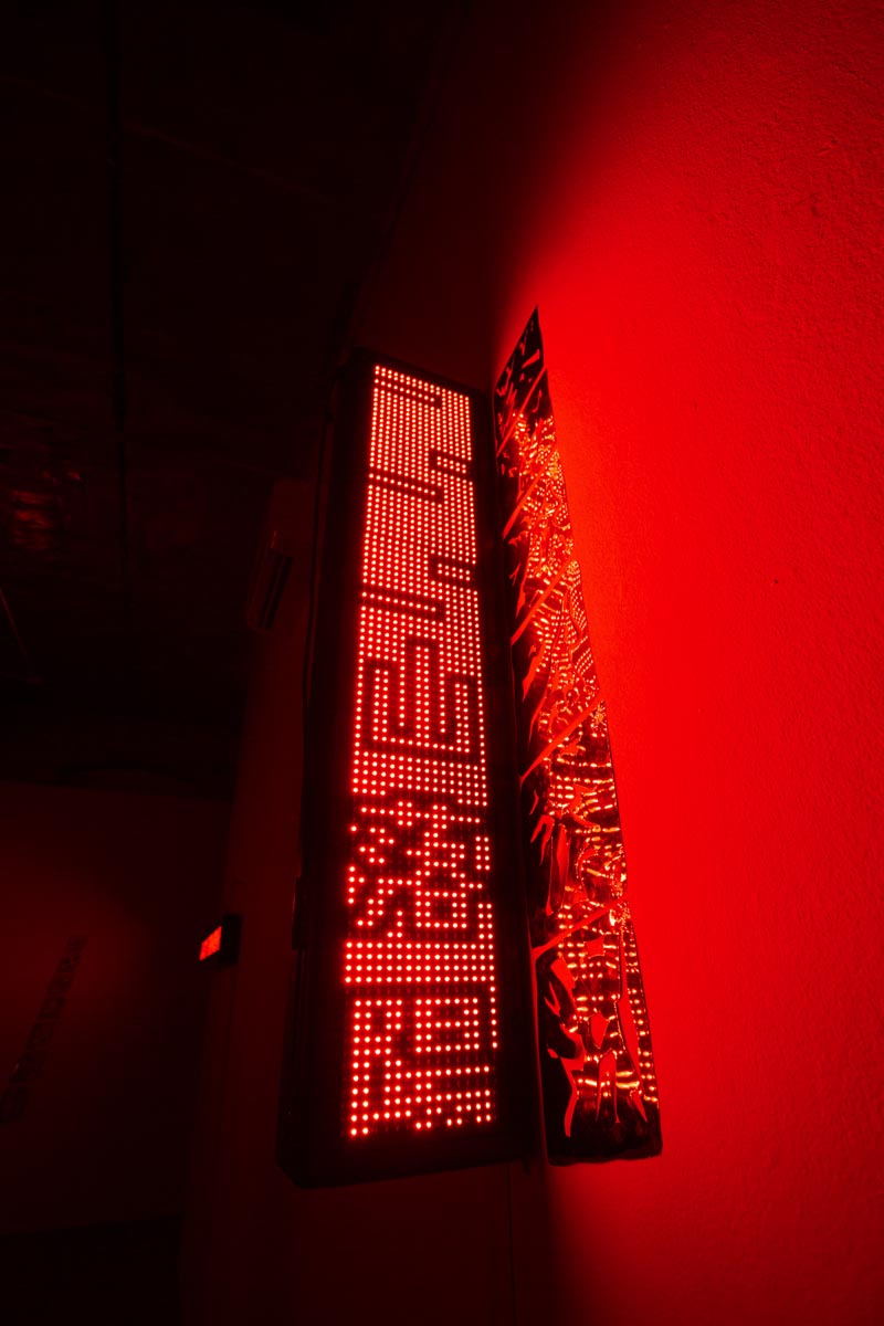 Detail shot, red room, dim lights, with LED signs.llation View, red room, dim lights, with LED signs.
