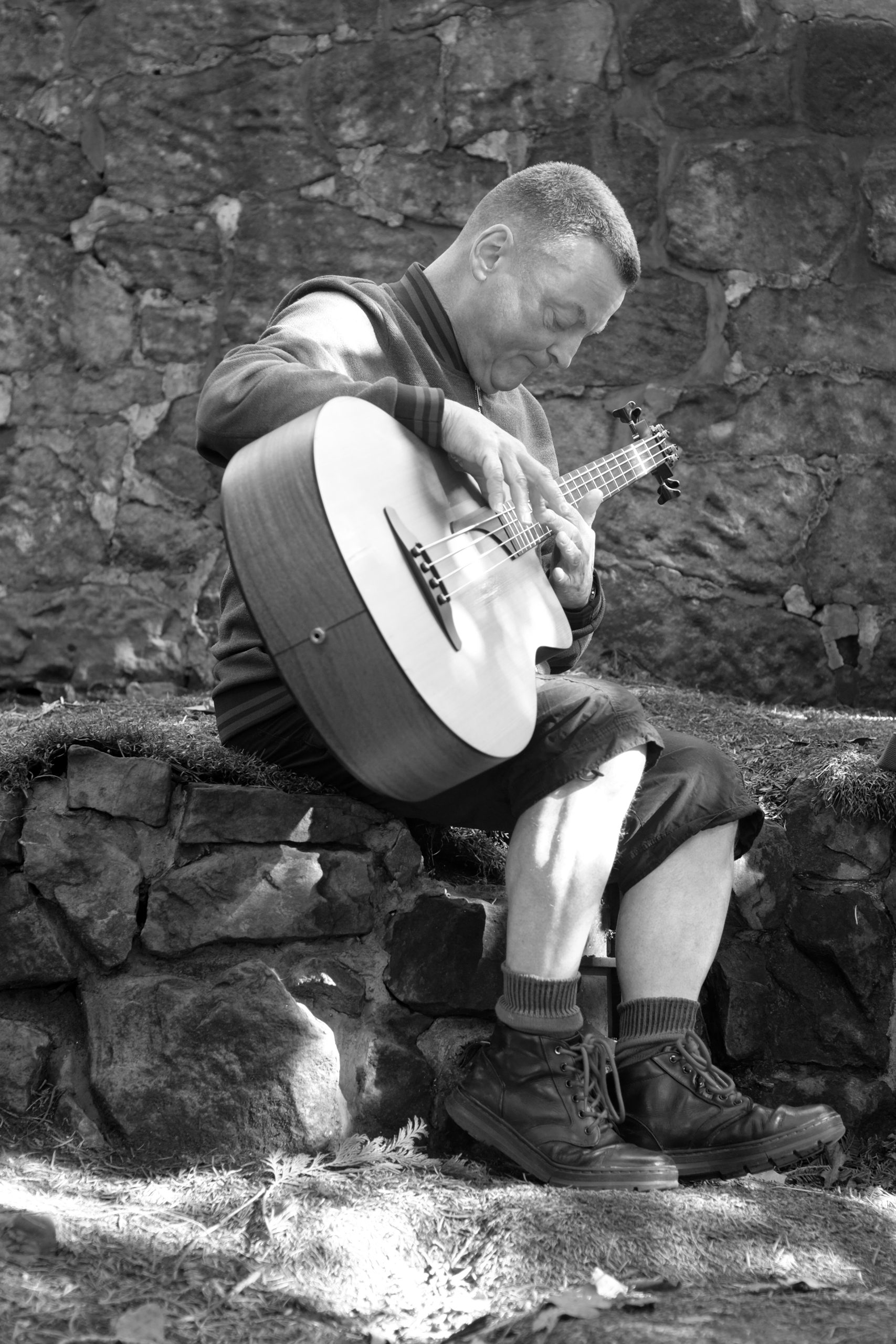 A man plays an acoustic guitar